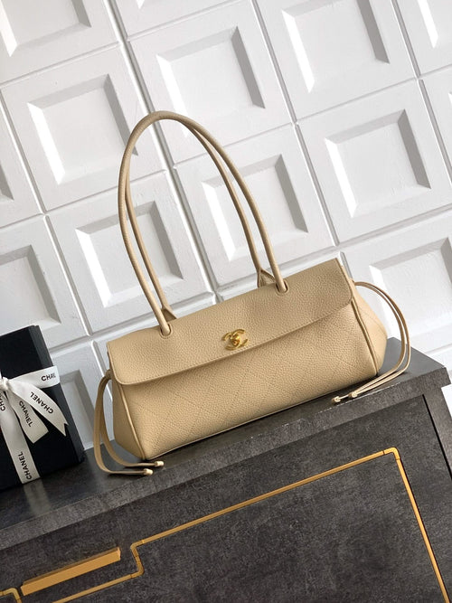 Beige Chanel leather handbag with top handles, gold-tone clasp and shoulder strap