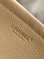 Beige Chanel leather interior panel with embossed CHANEL logo