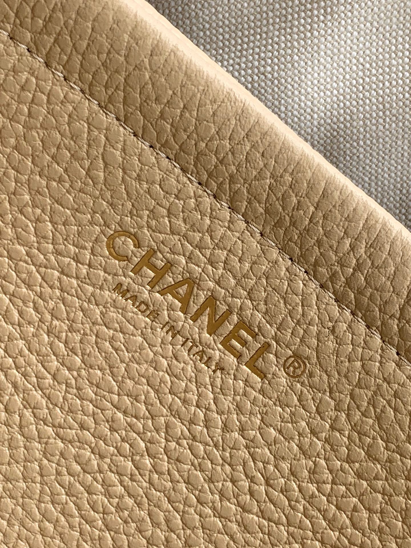 Beige Chanel leather interior panel with embossed CHANEL logo
