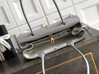 Chanel bag interior view in light gray leather with gold zipper hardware and straps