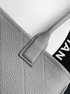Chanel light gray leather bag corner with quilted stitching and metal frame detail