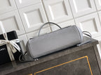 Chanel bag in light gray leather with flap front, top handle and shoulder strap