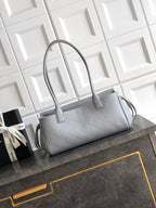 Chanel bag in light gray leather with quilted texture and top handles