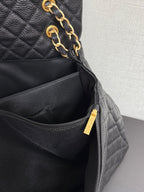 Black Chanel bag with gold zipper pull and interior zip pocket