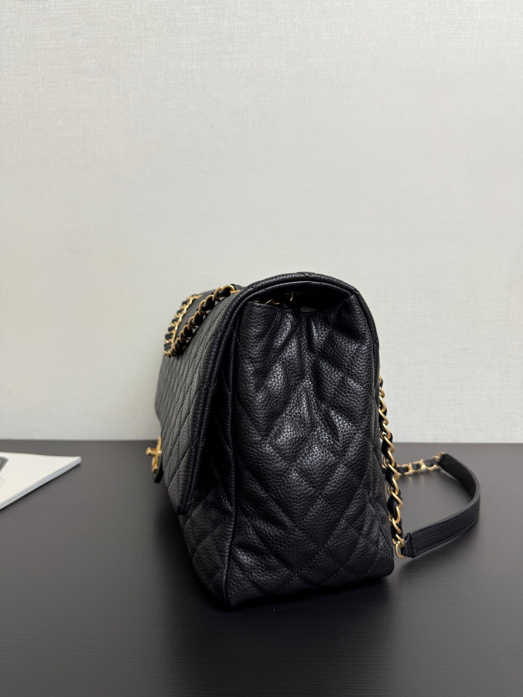 Black quilted Chanel bag with gold chain strap and leather top handle