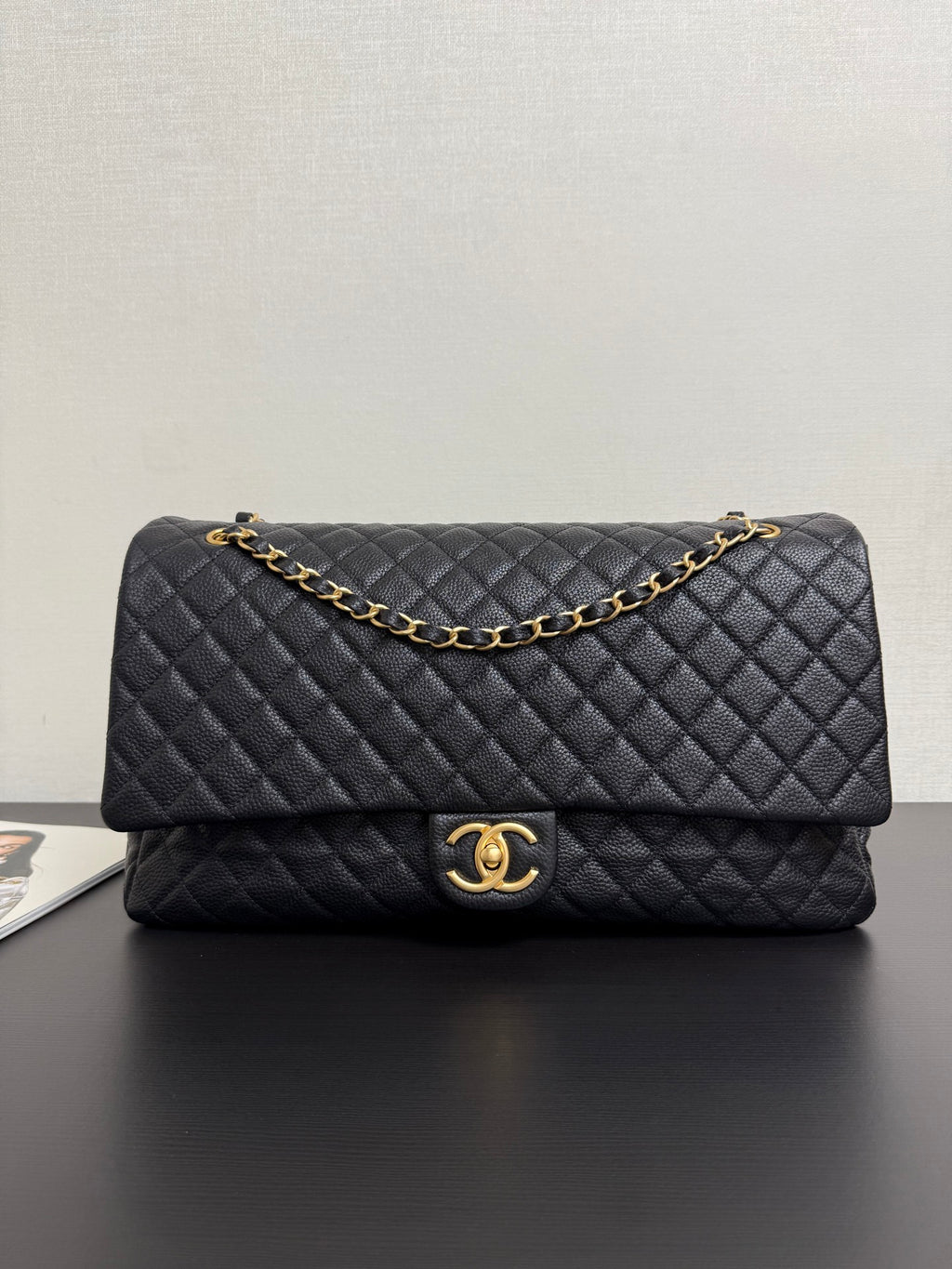 Quilted black Chanel bag with gold-tone chain strap and CC clasp
