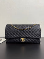 Quilted black Chanel bag with gold-tone chain strap and CC clasp