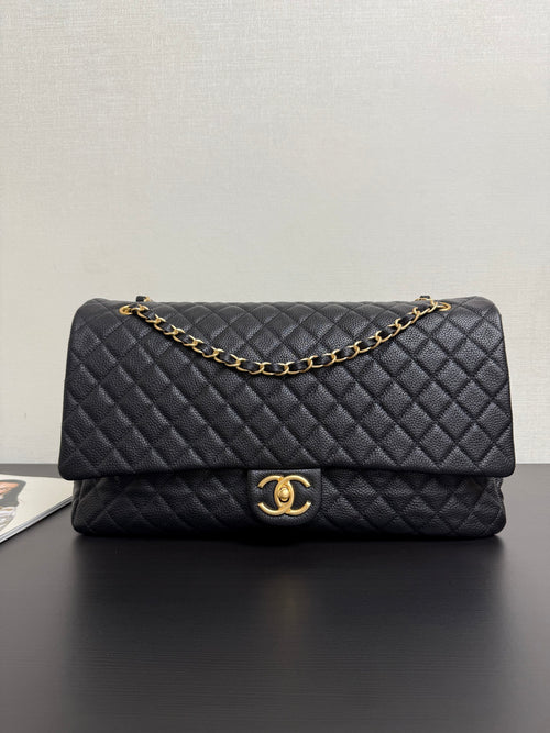 Quilted black Chanel bag with gold-tone chain strap and CC clasp