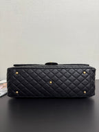 Quilted black Chanel handbag with gold studs and short chain handle