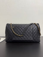 Quilted black Chanel bag with gold chain shoulder strap and CC logo front
