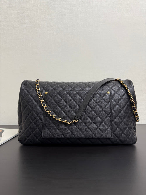 Quilted black Chanel bag with gold chain shoulder strap and CC logo front