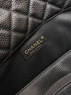 Black Chanel bag brand patch on quilted leather flap