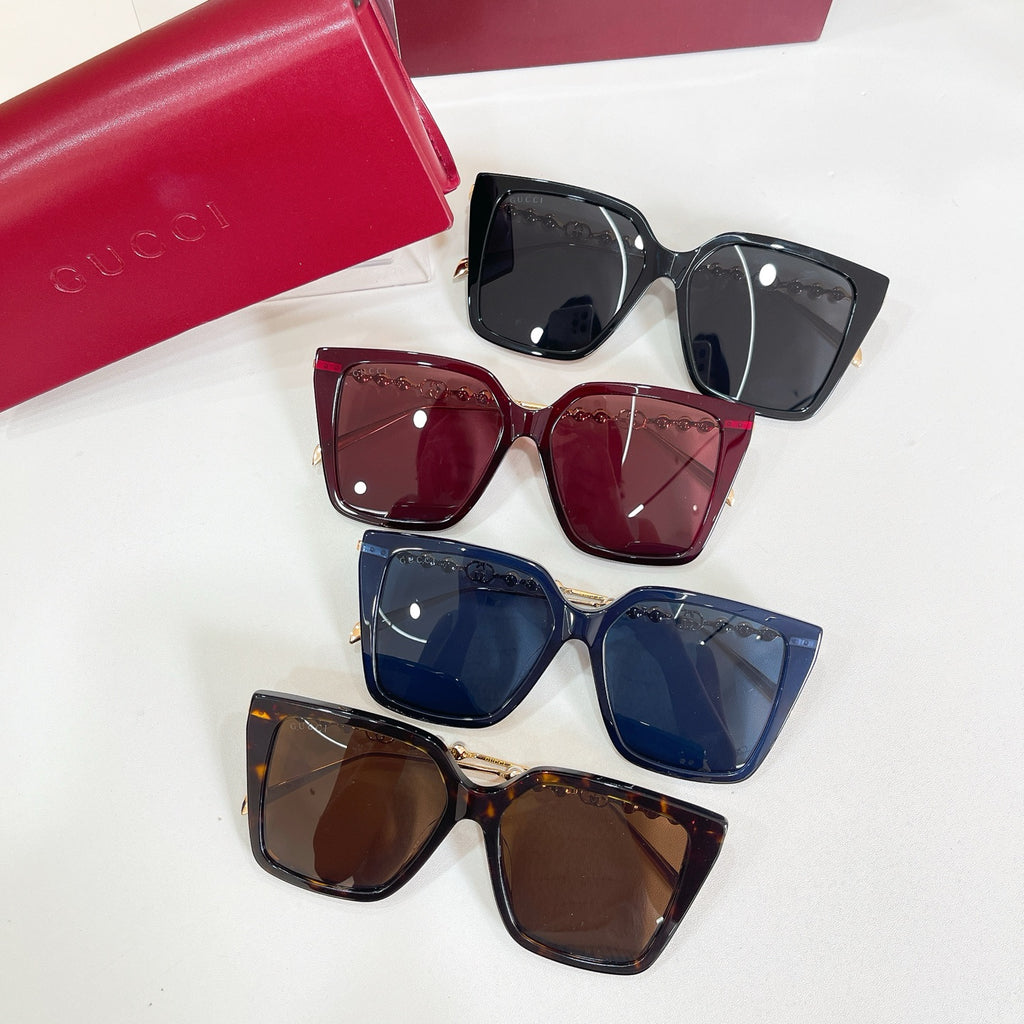 Set of four Gucci sunglasses: black, burgundy, blue, and brown square frames