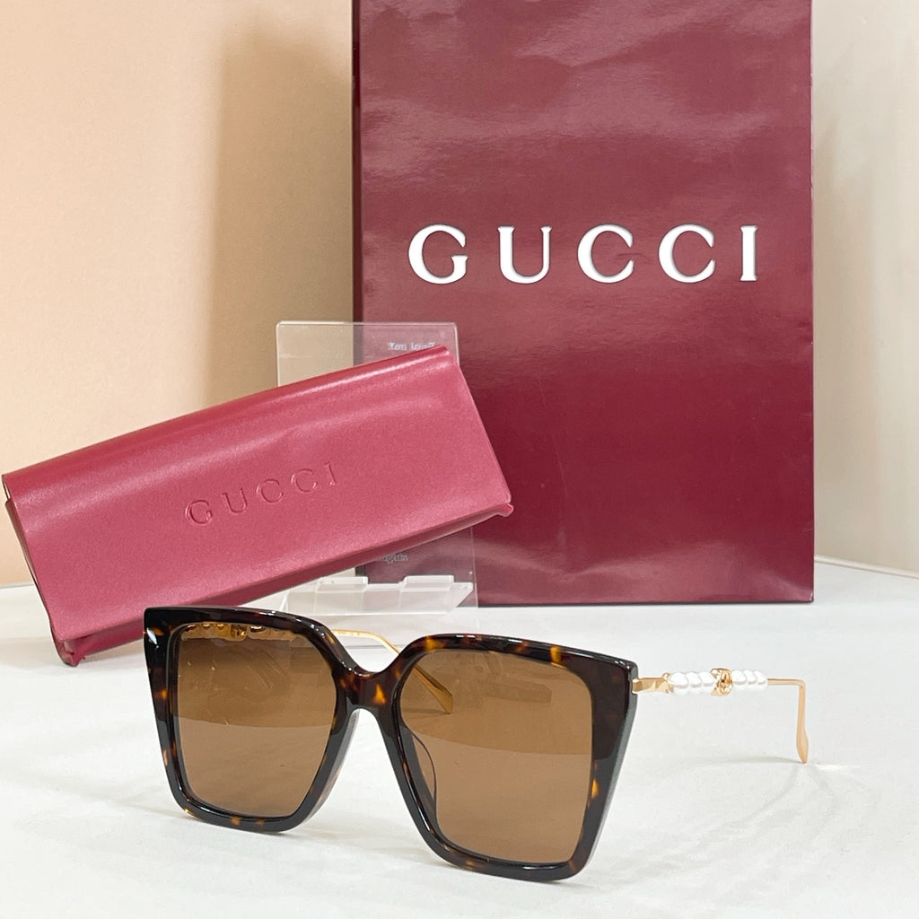 Gucci sunglasses with tortoiseshell frames and brown tinted lenses