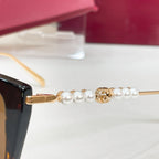 Gucci sunglasses temple detail with gold bar and pearl-bead accents