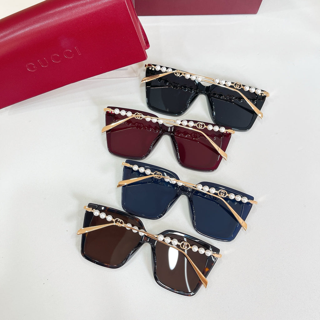 Set of four Gucci sunglasses with pearl trim and square tinted lenses in dark colors