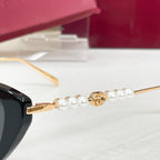 Sunglasses temple close-up with gold hardware and white pearl accents