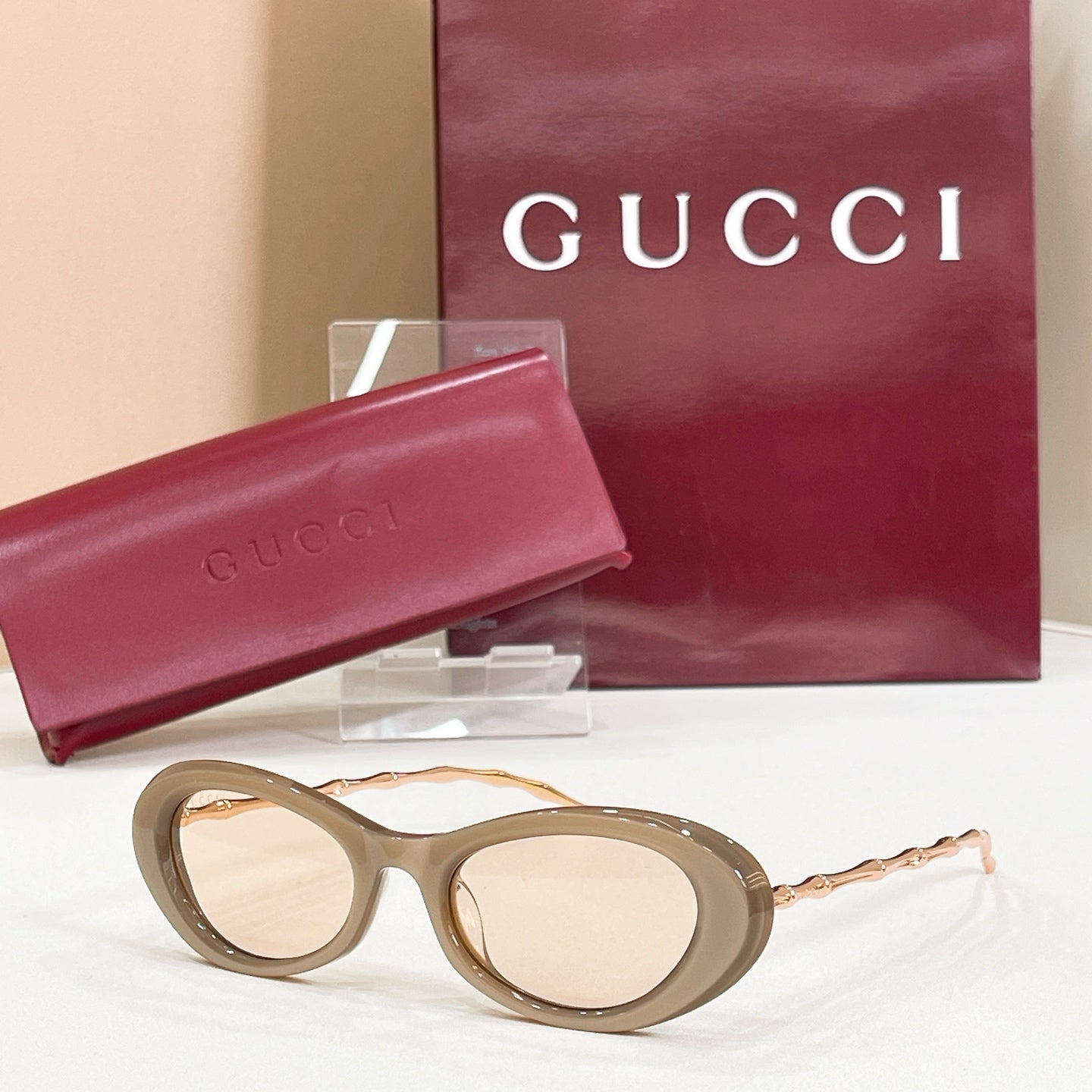 Gucci sunglasses, light brown round frames with clear/tan tinted lenses and gold-tone arms