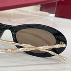 Gucci sunglasses side view: black frame with dark tinted lens and gold temple