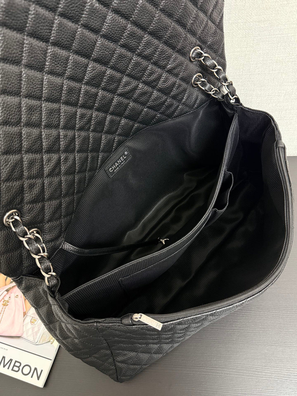 Chanel quilted shoulder bag interior with zipper trim and chain strap at top opening.