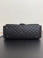 Chanel quilted top-flap bag in dark navy with gold-tone stud feet and front quilting.