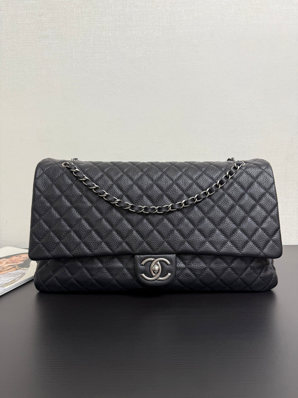 Chanel quilted flap bag in dark navy with chain strap and CC turn-lock clasp.