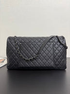 Chanel quilted shoulder bag in dark navy with chain strap and stitched diamond front panel.
