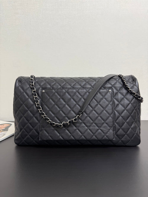 Chanel quilted shoulder bag in dark navy with chain strap and stitched diamond front panel.