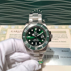 Rolex Submariner-style stainless steel watch with green bezel and black dial