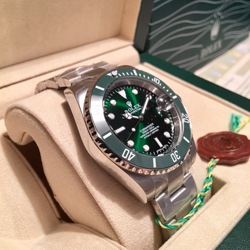 Rolex stainless steel watch with green bezel and black dial in display box