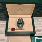 Rolex stainless steel watch with green bezel and black dial in open presentation case