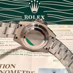 Rolex stainless steel watch case close-up with green accent ring on bezel