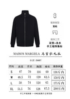Black zip-front knit jacket with stand collar and ribbed cuffs
