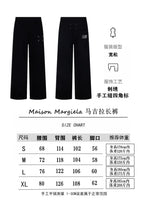 Black wide-leg trousers front and back views with size chart