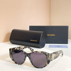 Tortoiseshell sunglasses with dark lenses, with black case