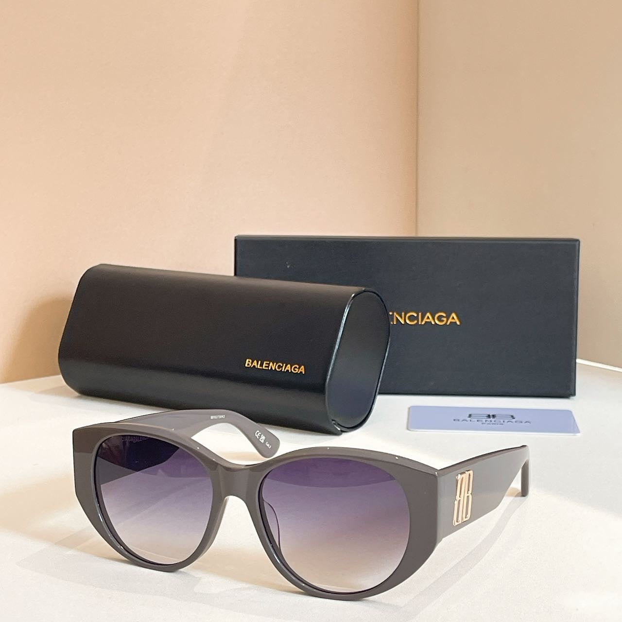 Gray sunglasses with purple lenses, with black case