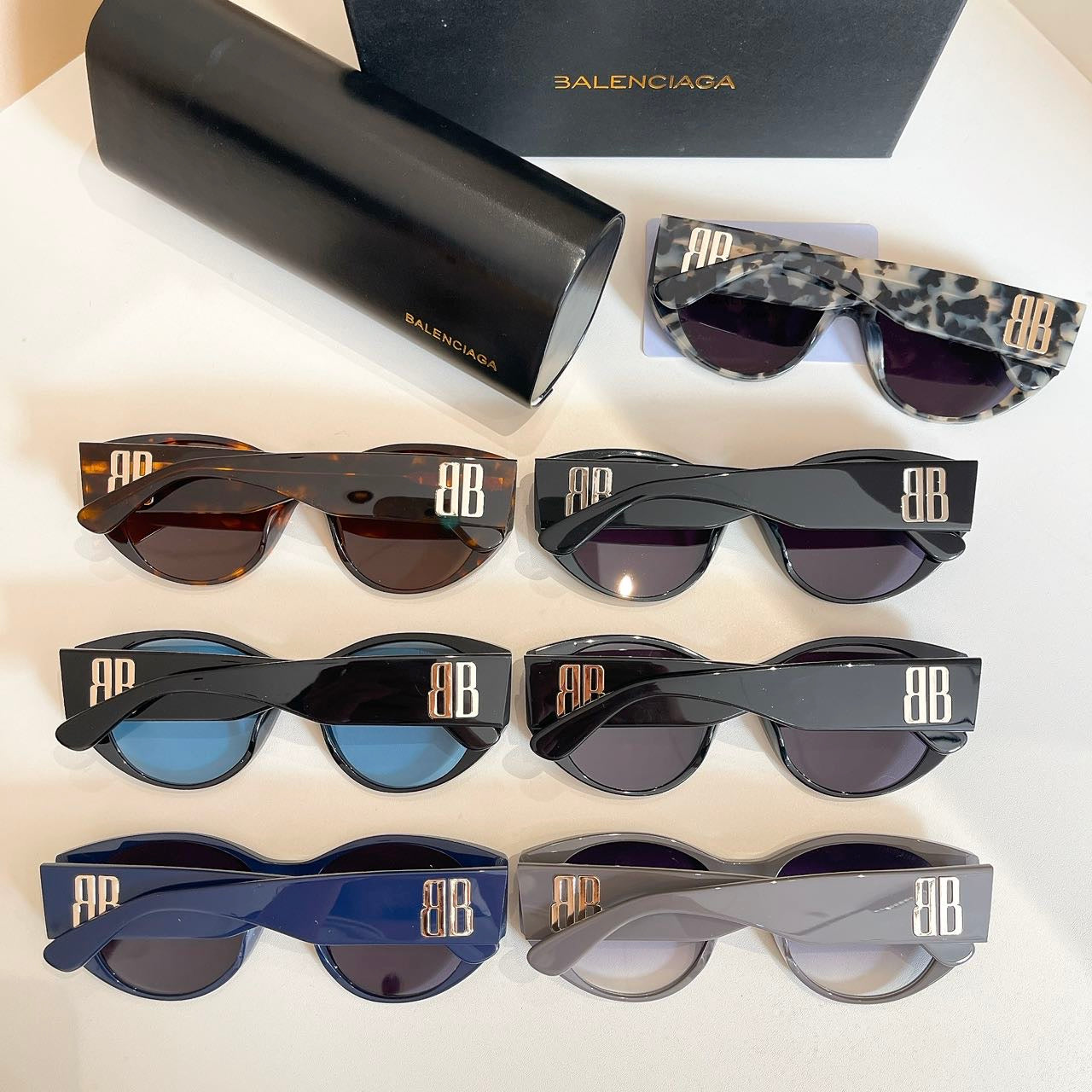 Assorted sunglasses set with colored frames and lenses, with black case