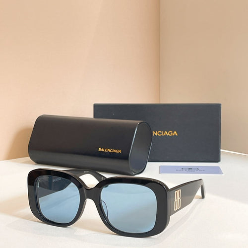 Black sunglasses with oversized rounded frames and light blue tinted lenses, logo on temple