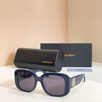 Navy sunglasses with oversized rounded frames and purple tinted lenses, logo on temple