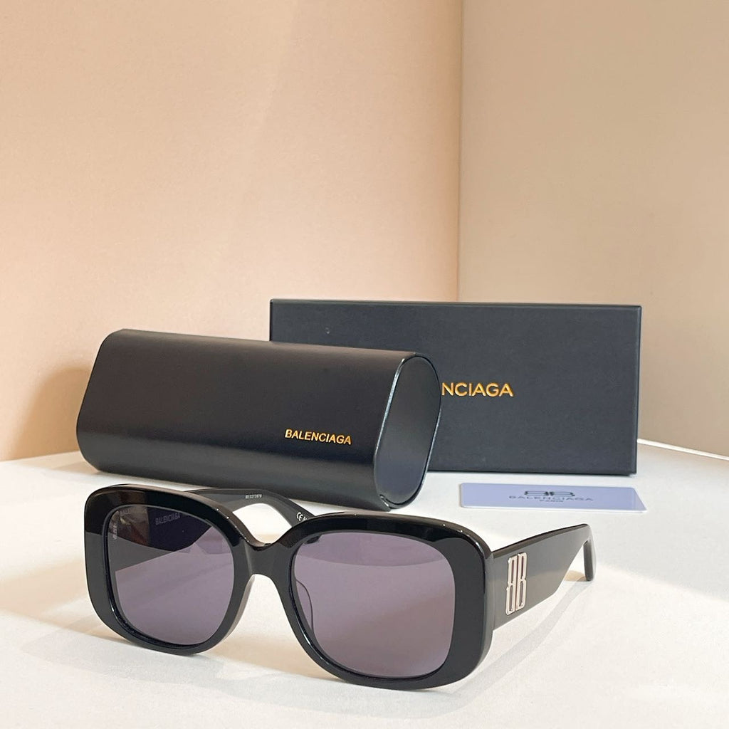 Black sunglasses with oversized rounded frames and pale purple tinted lenses, logo on temple