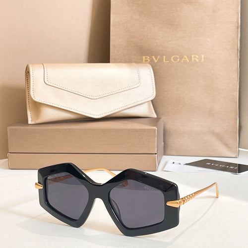 Octagonal sunglasses with dark frames and tinted lenses, gold-tone temples.
