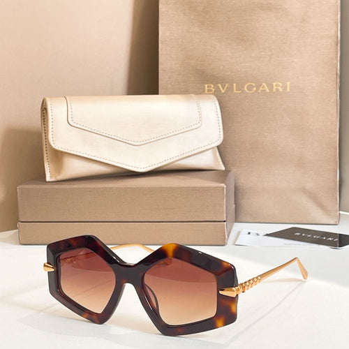 Octagonal sunglasses with tortoiseshell frames and gradient amber-tinted lenses.
