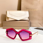 Octagonal sunglasses with magenta frames and purple-tinted lenses, gold-tone details.