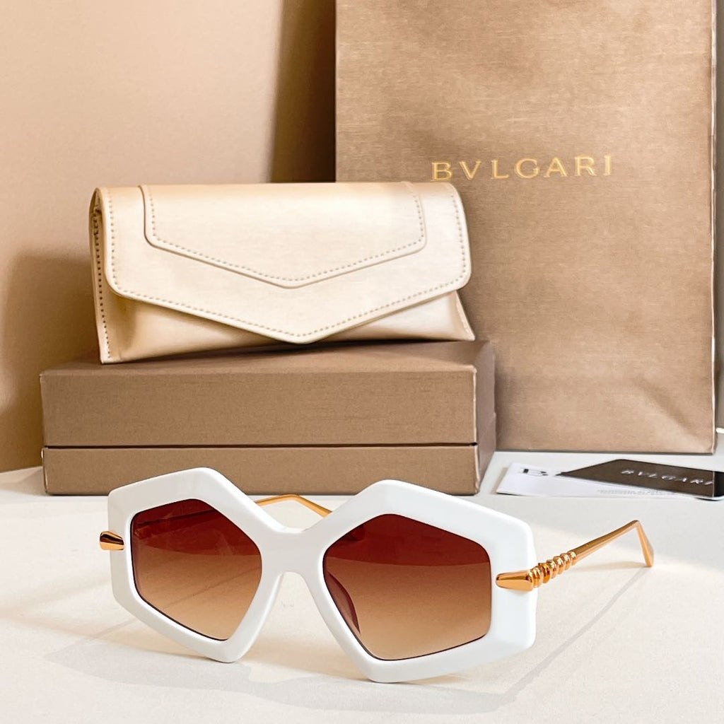 Octagonal sunglasses with white frames and red-tinted lenses, gold-tone temples.