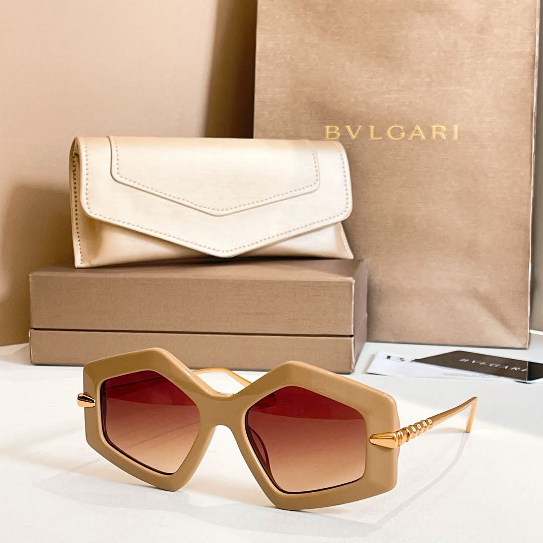 Octagonal sunglasses with beige frames and red-tinted lenses, gold-tone accents.