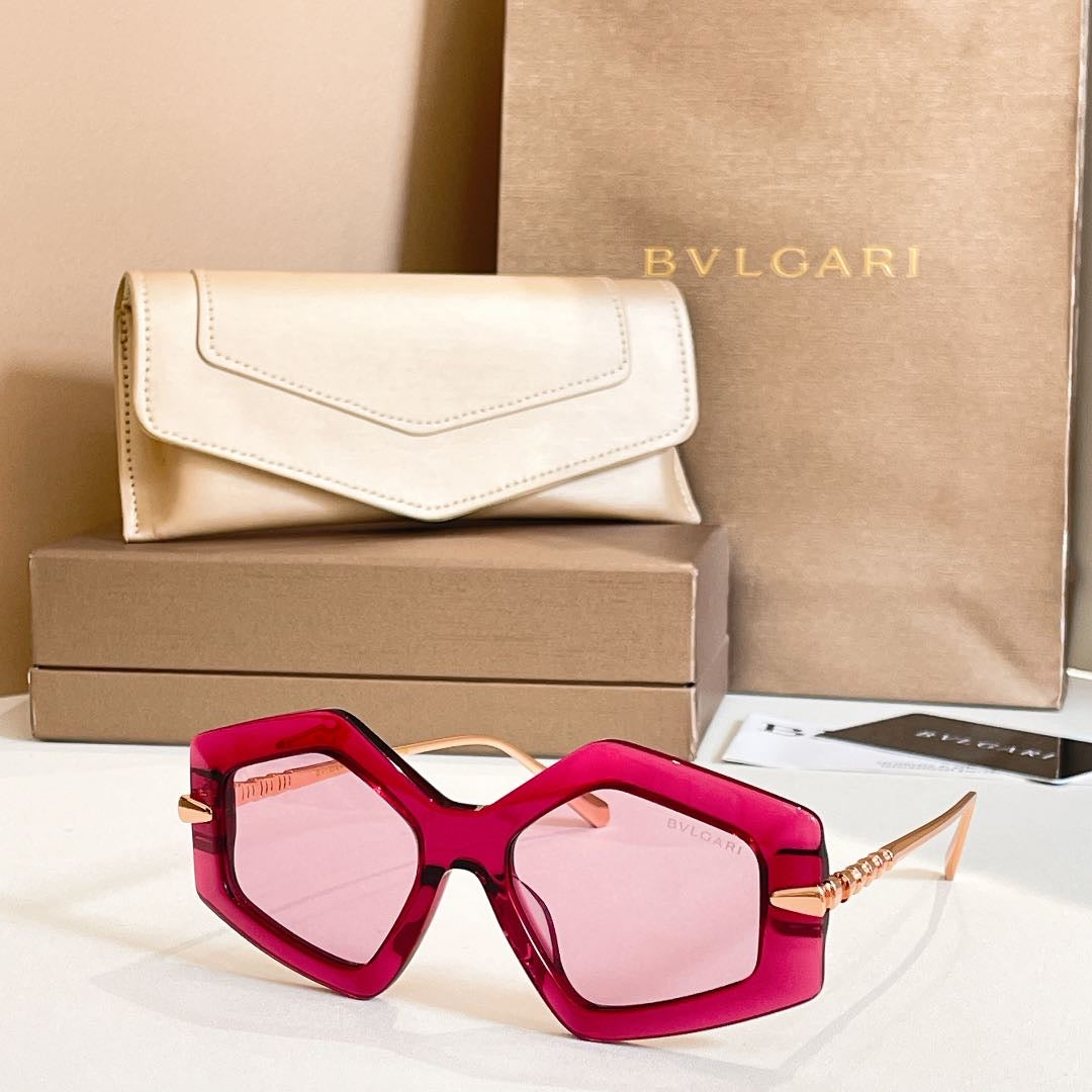 Octagonal sunglasses with red frames and pink-tinted lenses, gold-tone temples.