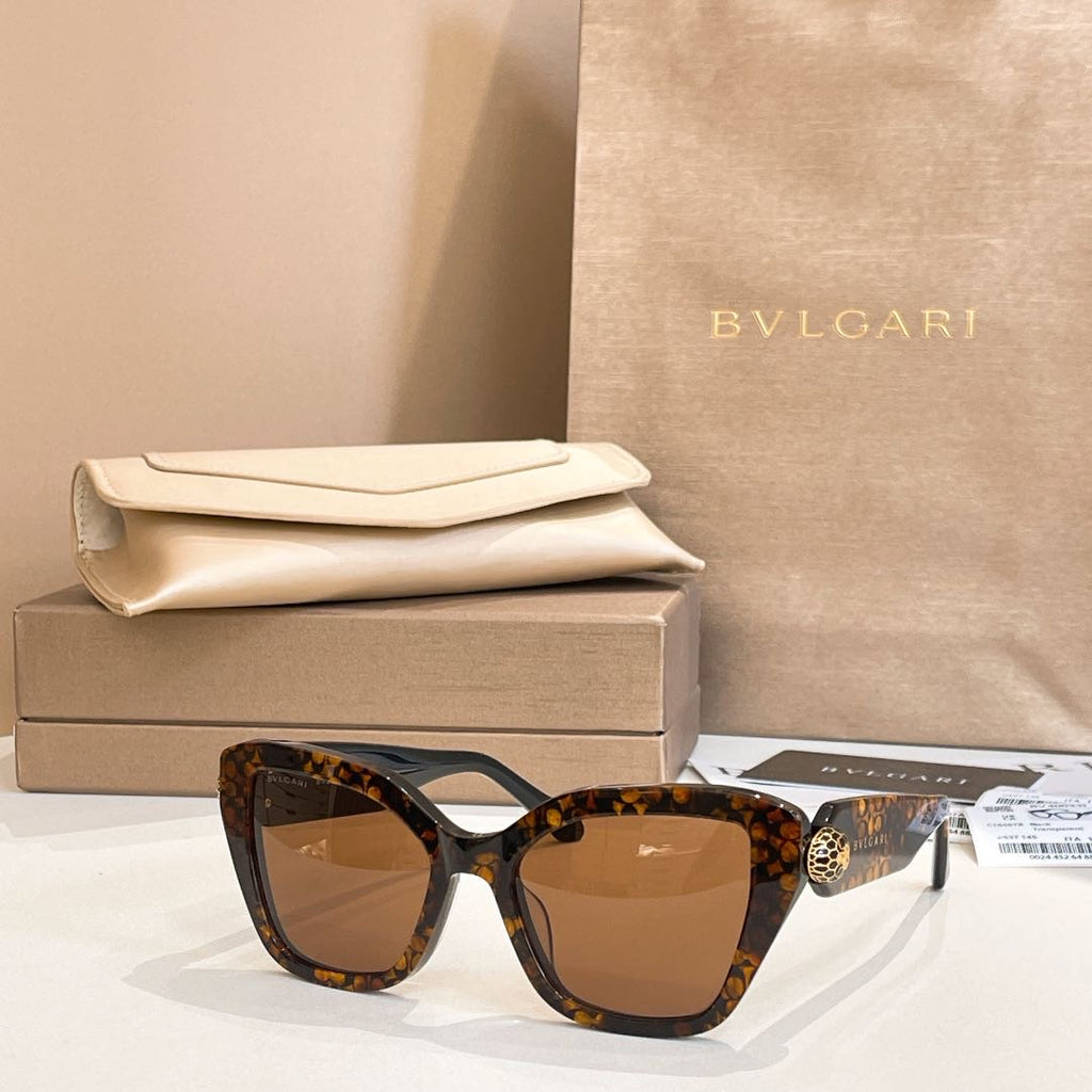 Tortoiseshell square glasses with brown-tinted lenses and gold-tone temple detail.