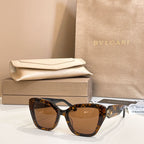 Tortoiseshell square glasses with brown-tinted lenses and gold-tone temple detail.