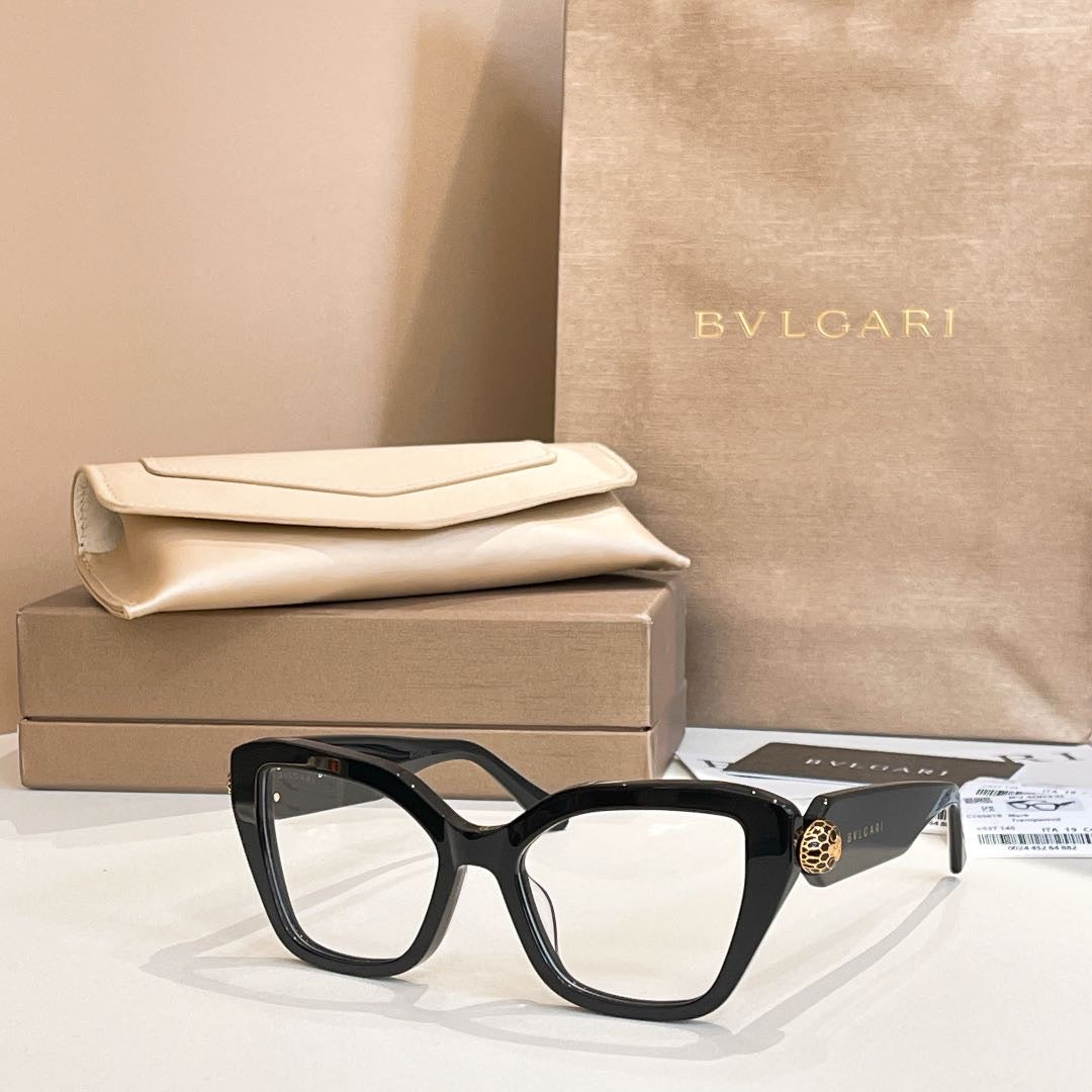 Black square glasses with clear, lightly tinted lenses and gold-tone temple detail.