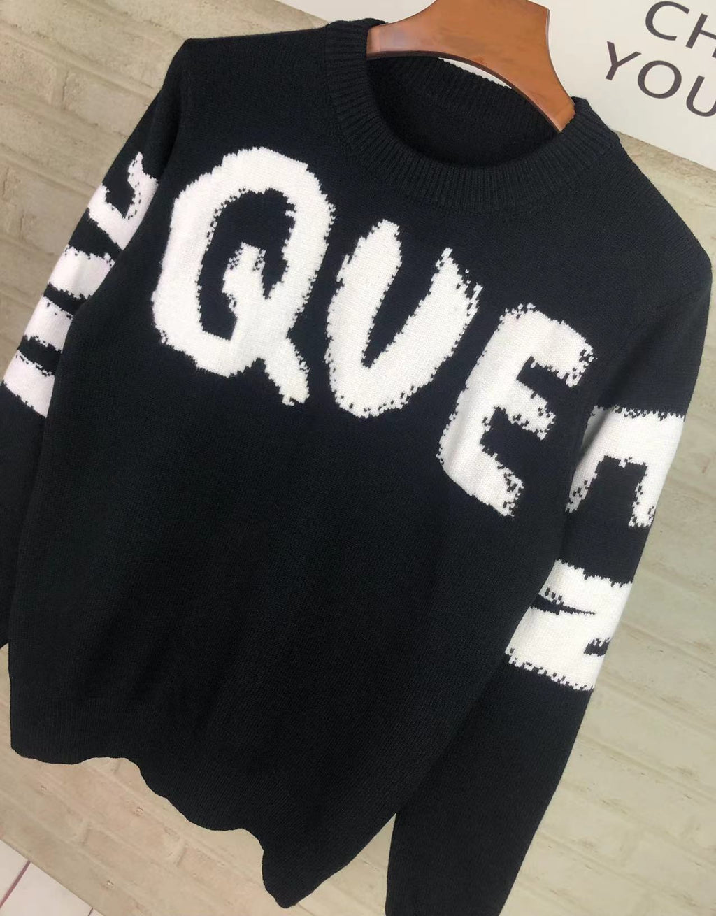 Alexander McQueen knit sweater in black with large white QVE lettering